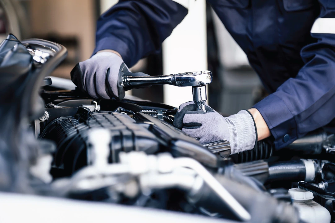 auto repair technician working on car engine