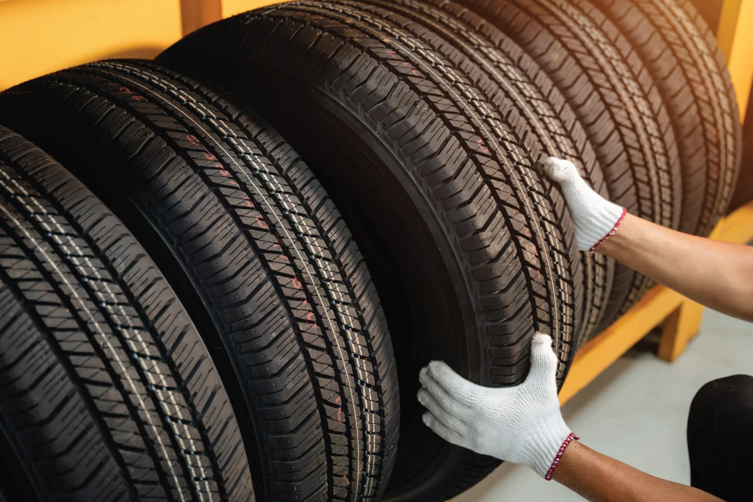 technician selecting a tire from a rack